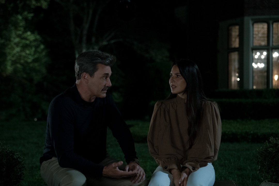 Jon Hamm, as Coop, and Olivia Munn, as Sam, have a serious conversation, sitting in a dark backyard at night.